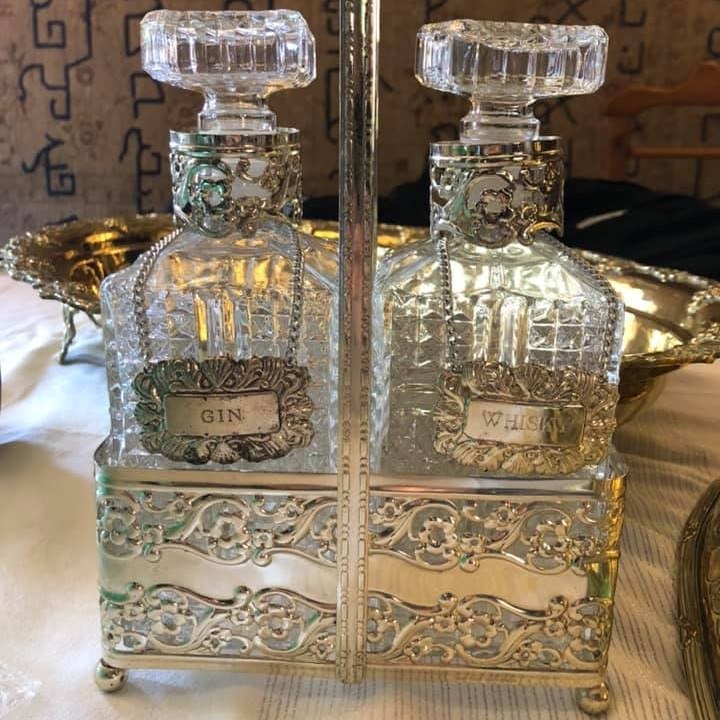 Vintage 2 bottle decanter set in a silver plated tantalus with silver plated Gin and Whiskey labels.