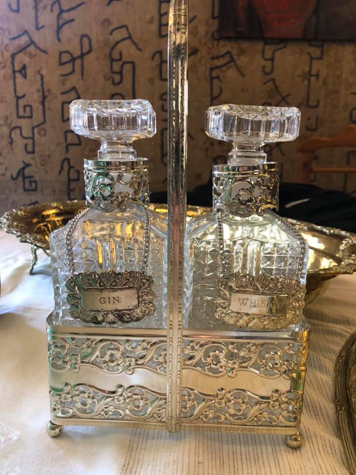 Vintage 2 bottle decanter set in a silver plated tantalus with silver plated Gin and Whiskey labels.