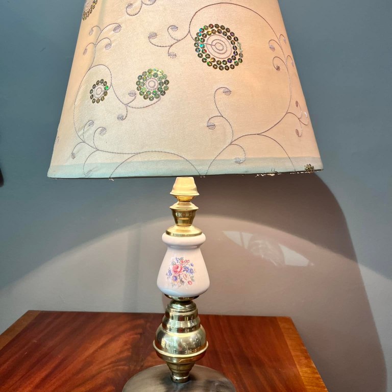 Lamp with brass and hand painted porcelain base and decorated cream shade: R800