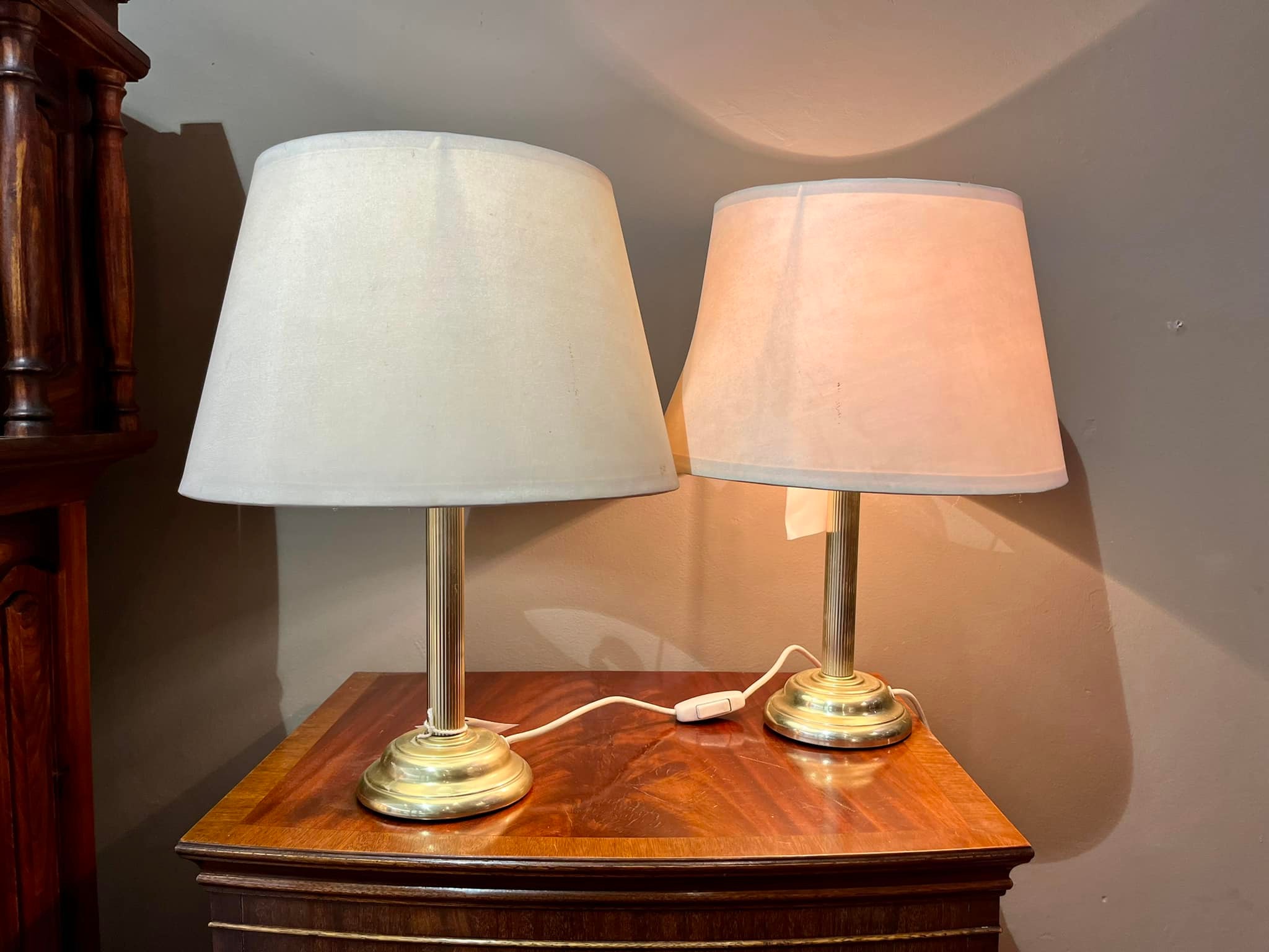 Pair of lamps with brass pillar bases and white shades: R1,600