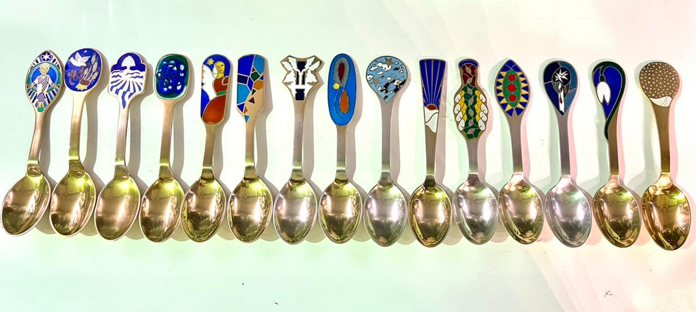 Anton Michelsen Danish Christmas Spoon collection 15 spoons collected from 1984 to 2006. The designer dessert spoons are gold plated sterling silver (800 grams in total) with enamel designs: POR