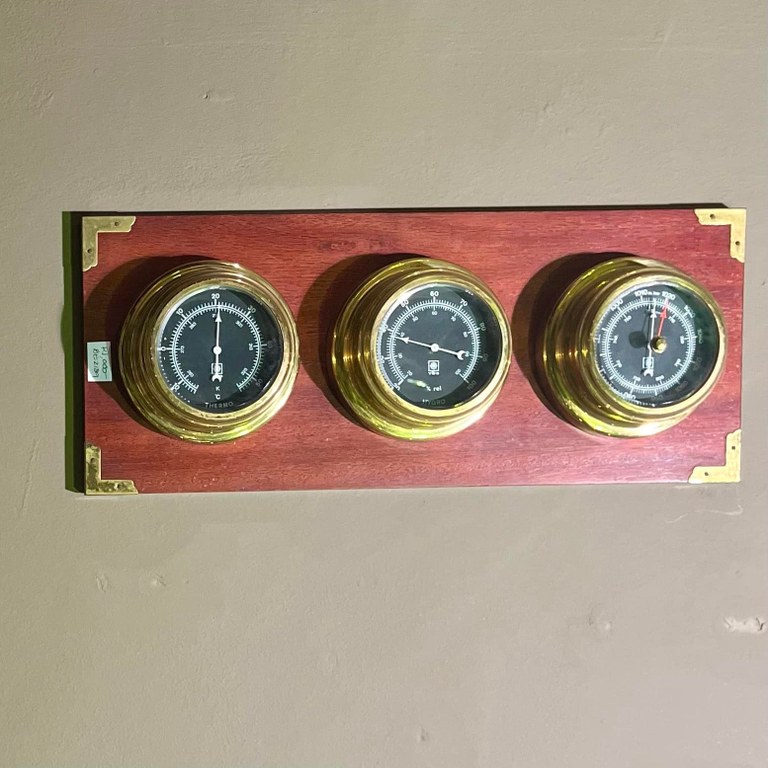 Three vintage thermometers set on wood backing: R1,000