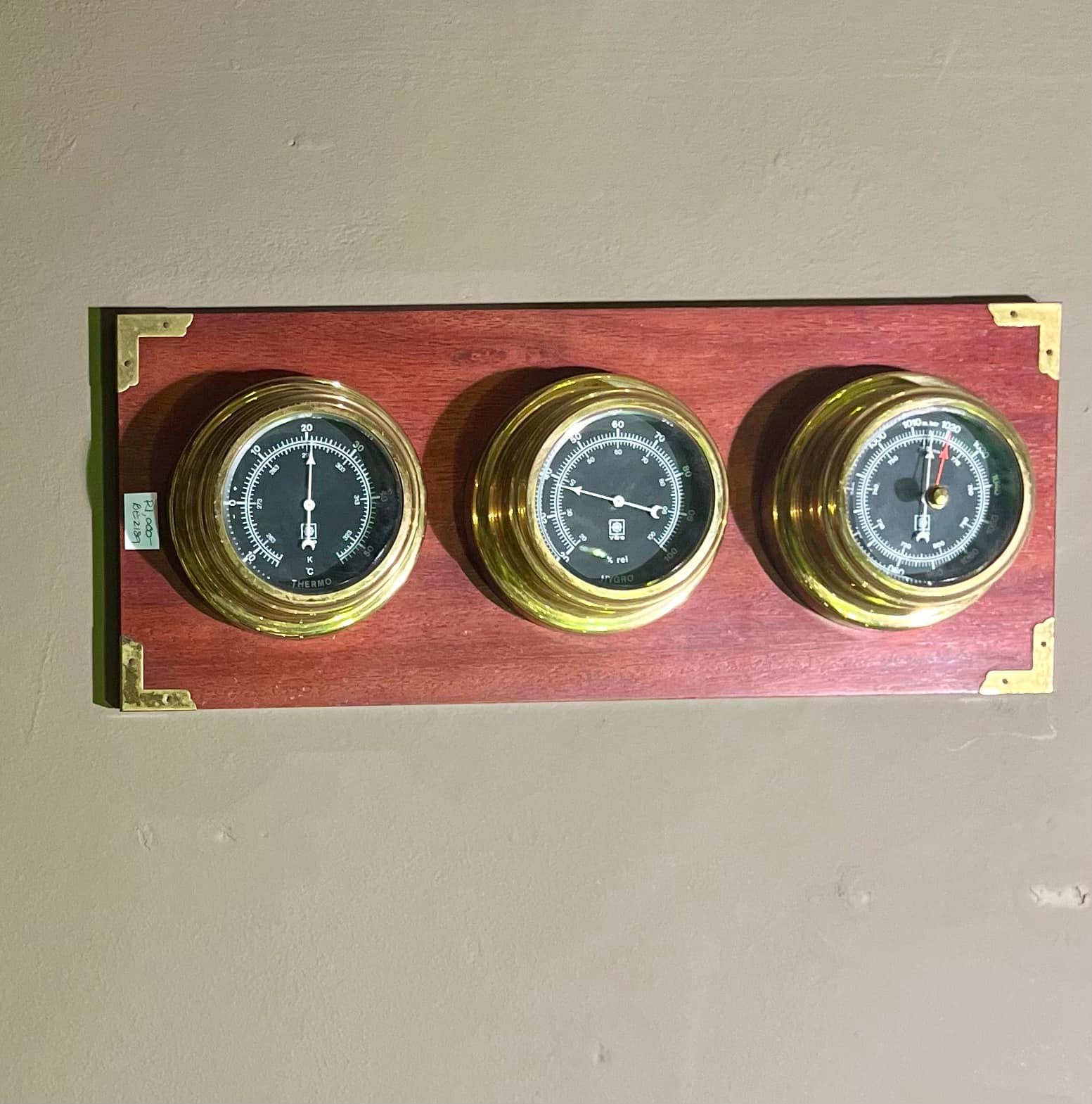 Three vintage thermometers set on wood backing: R1,000