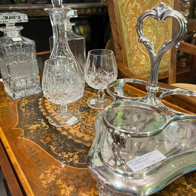 Variety of cut crystal decanters (R1,500 each) and cut crystal glasses (R200 each), Art Nouveau silver plated cruet: R2,500