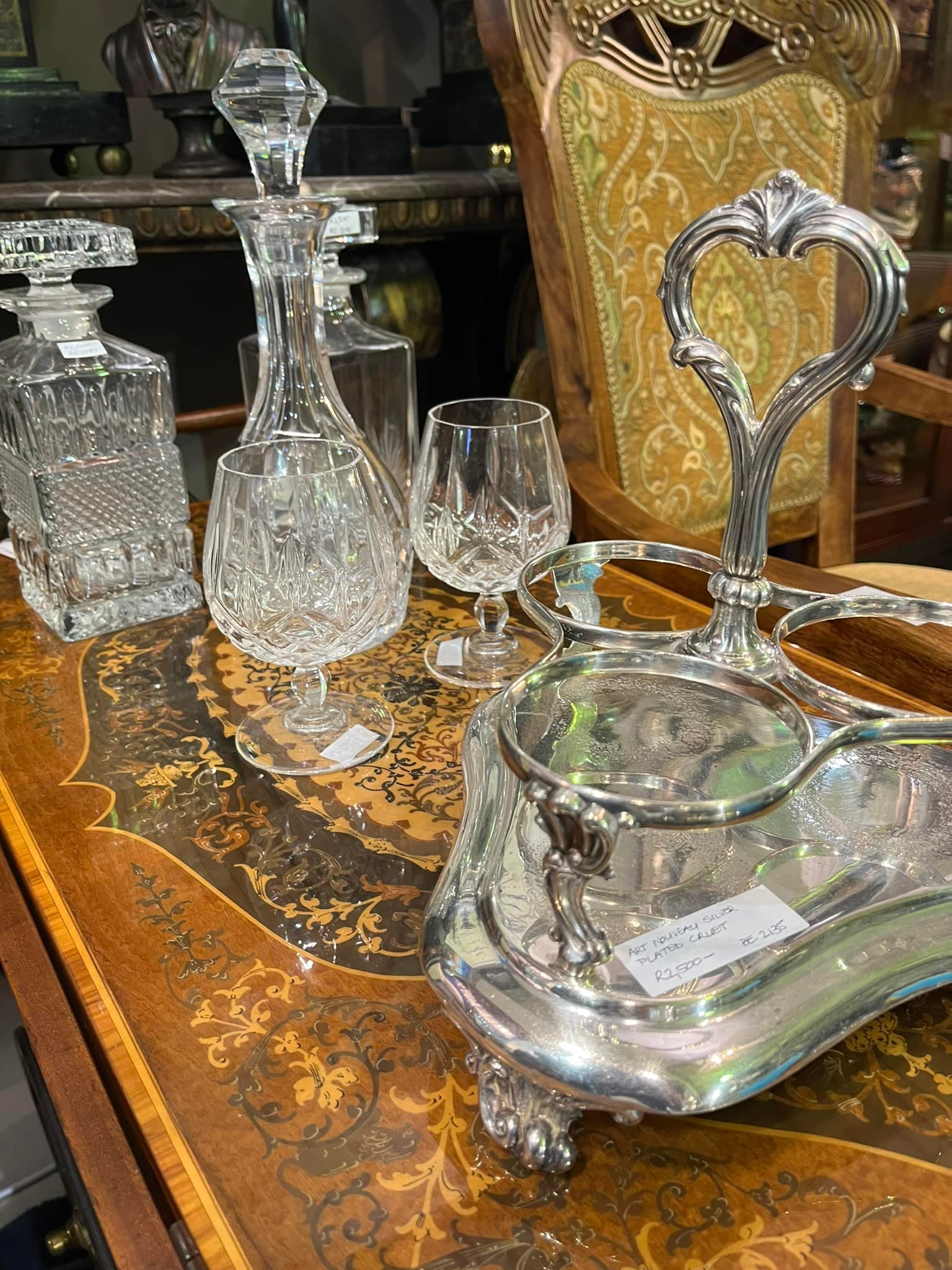 Variety of cut crystal decanters (R1,500 each) and cut crystal glasses (R200 each), Art Nouveau silver plated cruet: R2,500