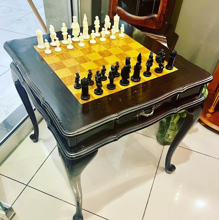 Vintage ebonised chess table with chess pieces: R8,000