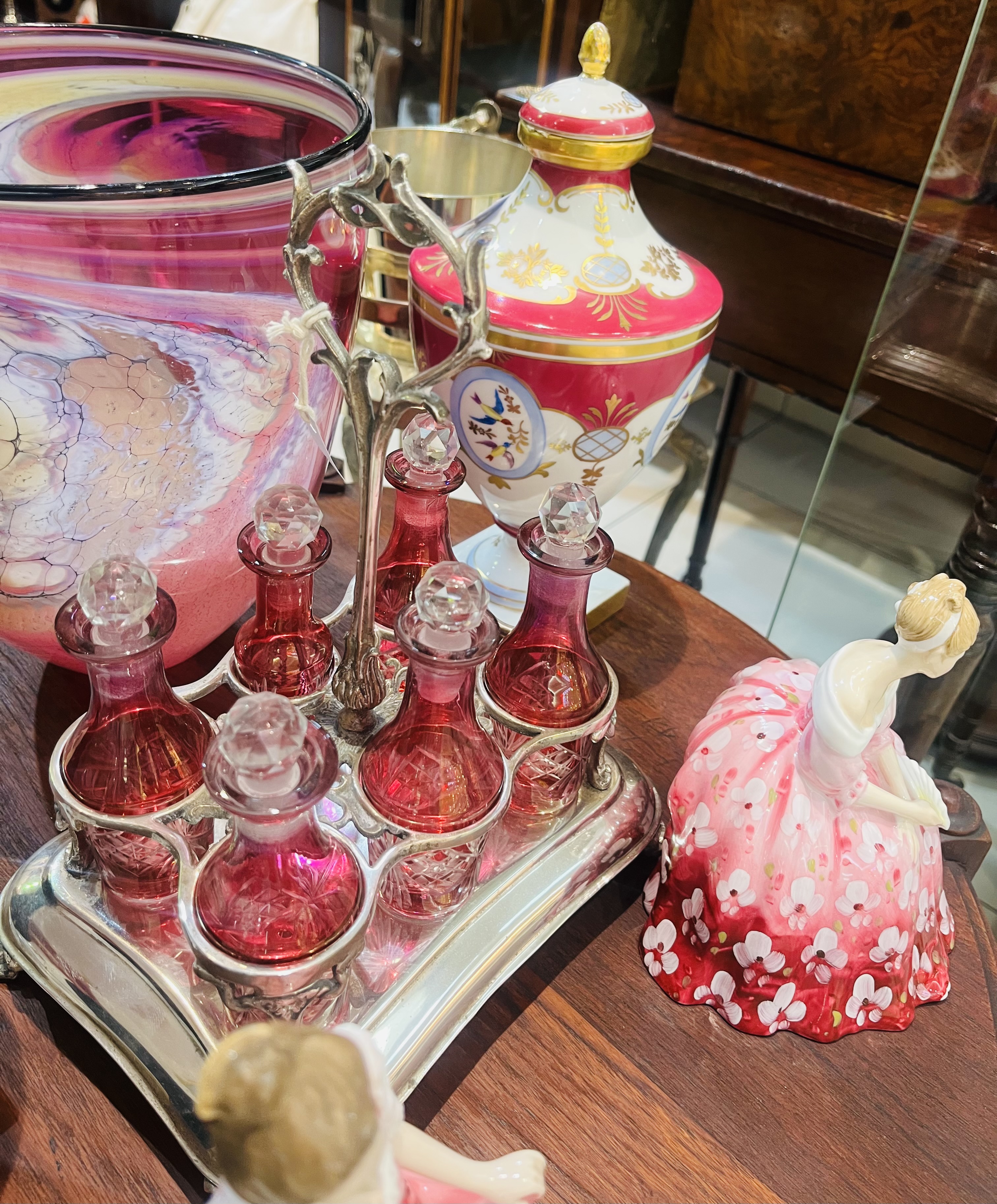 Early 1900s silver plate cruet stand with six cranberry crystal decanters