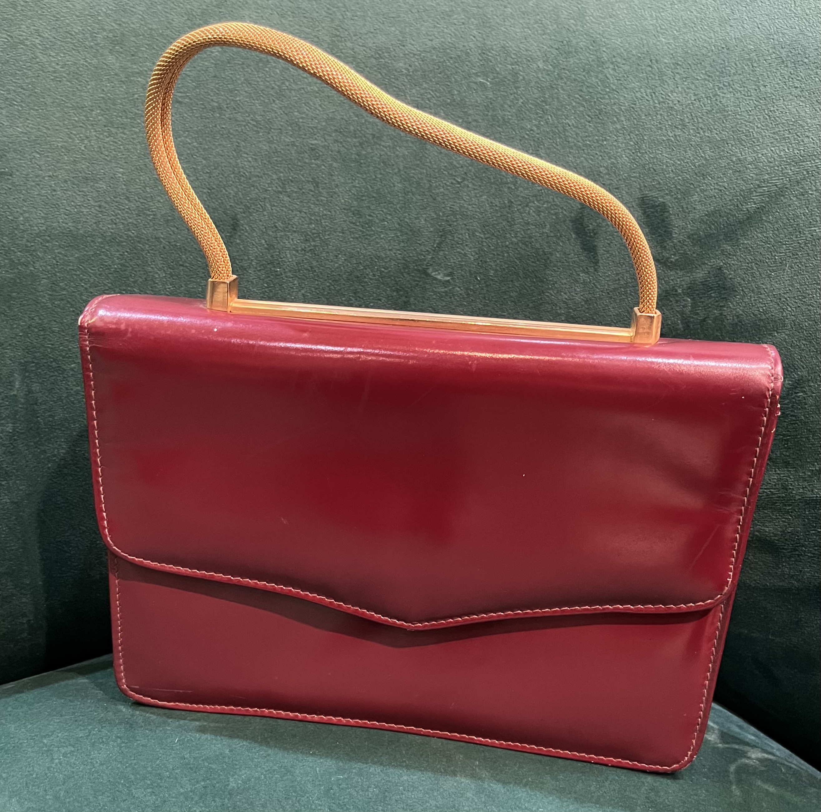 Patent leather fold over handbag with gold tone chain handle