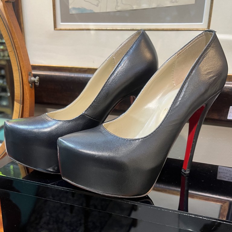 Pair of Christian Louboutin black leather platform stiletto heels, iconic red sole, size 39, minor wear