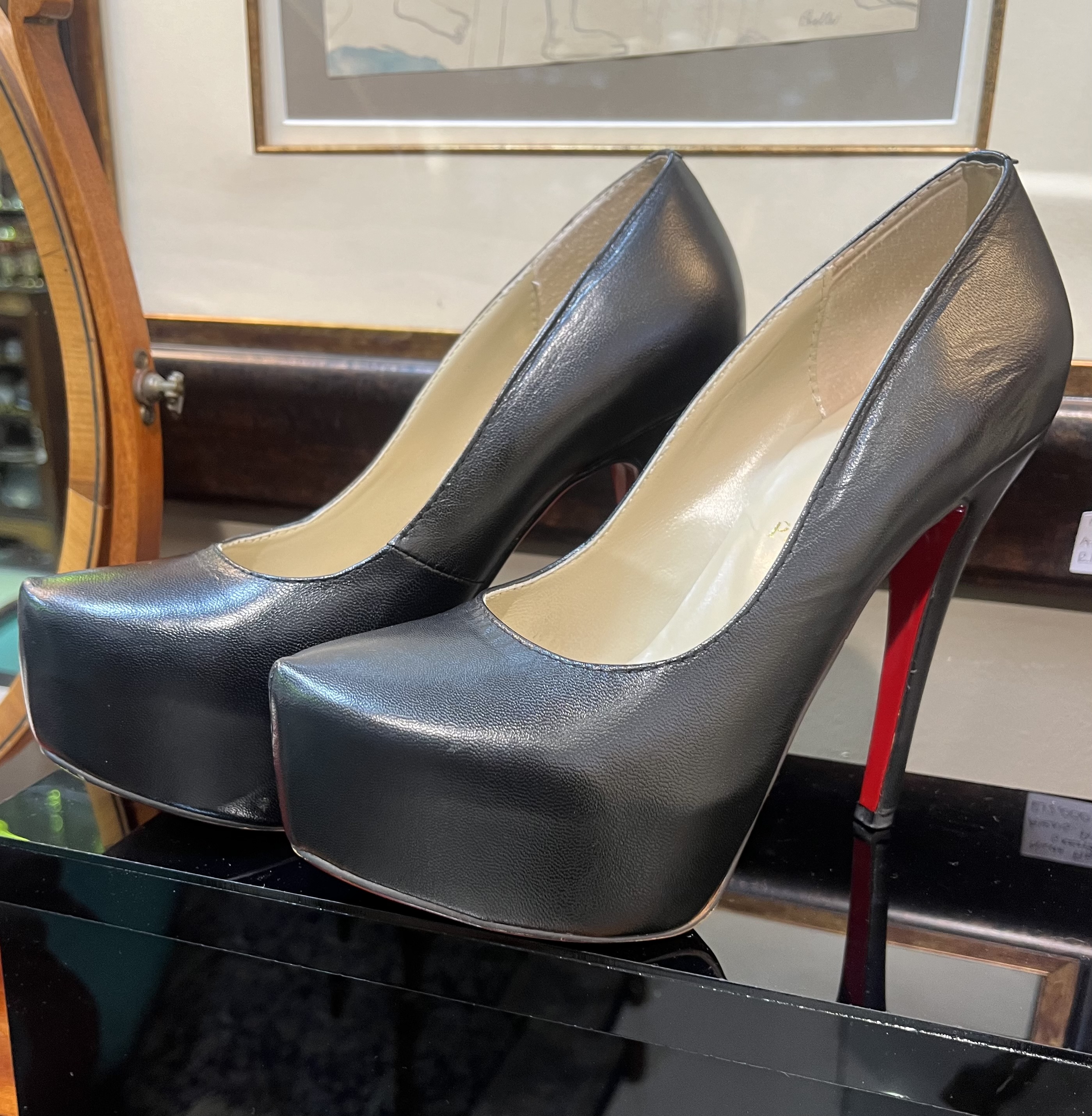 Pair of Christian Louboutin black leather platform stiletto heels, iconic red sole, size 39, minor wear