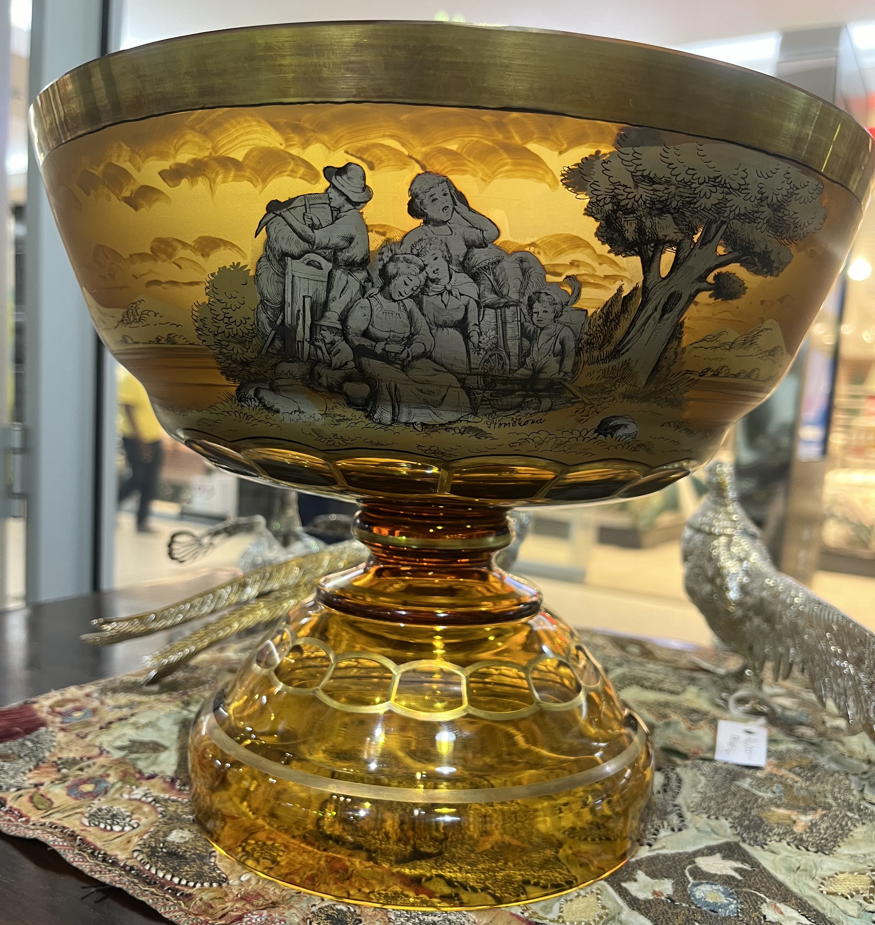 Moser amber glass and gilt footed bowl, decorated with continuous pastoral and figural scenes, signed, 23 x 28 cm