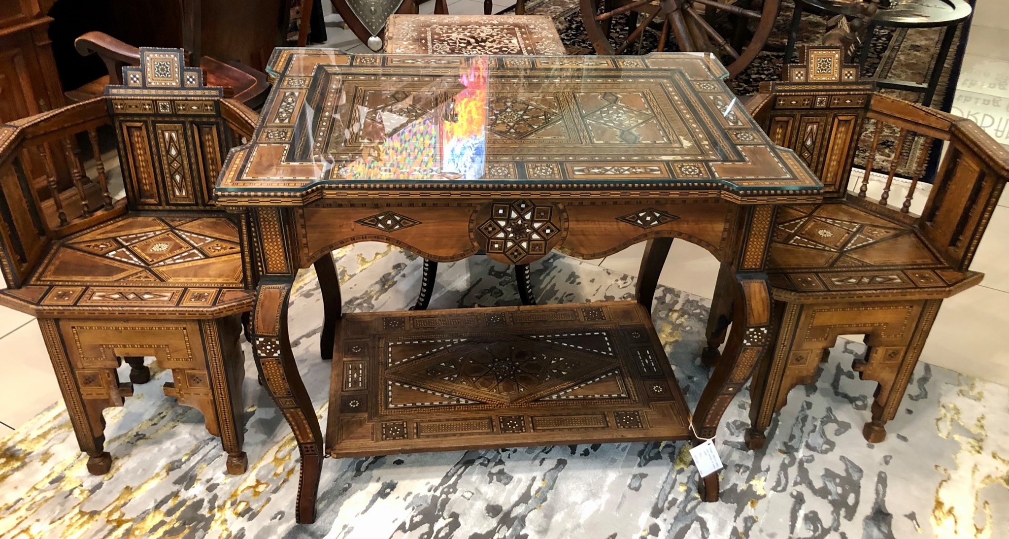 Early 20th Century Syrian games table and chairs with multiple geometric and asymmetric marquetry in various woods and mother-of-pearl. Table Size: 0.78m (height) x 0.94m (width) x 0.62m (depth)  Price for table and chairs set: R90,000.00