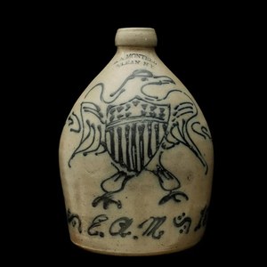 A STONEWARE JUG WITH FEDERAL EAGLE SIGNED E.A. MONTELL