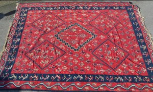 LARGE KELIM CARPET WITH A FIVE MEDALLION AND ALL-OVER FLORAL STYLISED DESIGN ON A RED GROUND