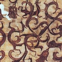 Detail of an embroidered silk gauze ritual garment. Rows of even, round chain stitches are used both for outline and to fill in color. The presence of wingless dragons are all over. From a 4th century BC, Zhou era tomb at Mashan, Hubei province, China.